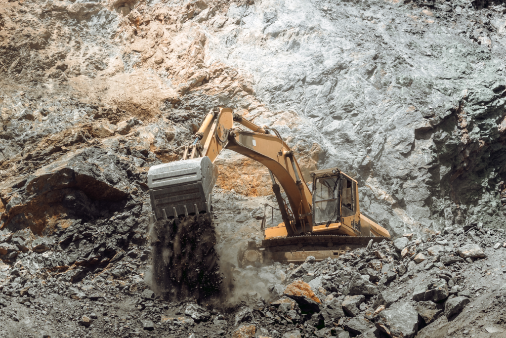 Digger on site breaking up rocks