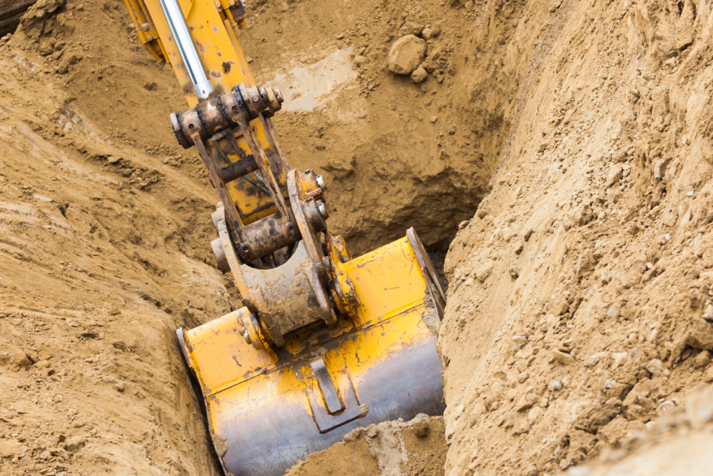 Digger on site diggin dirt and sand