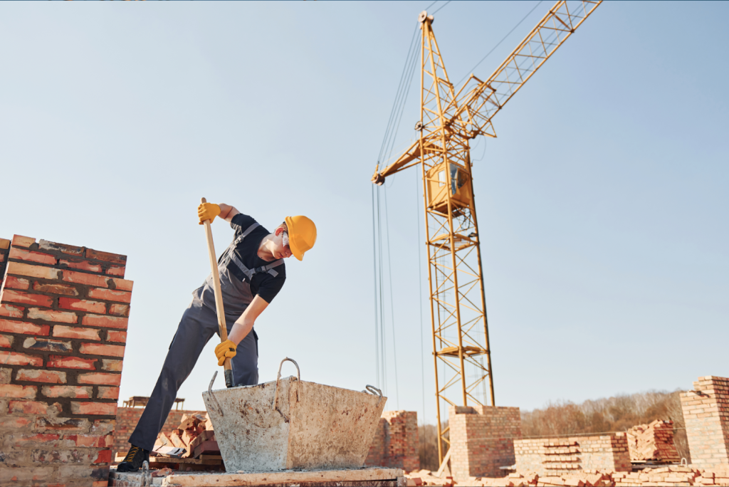 Man Digging With Crane In Background